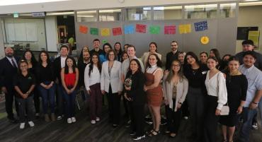 Senator Catherine Cortez-Masto stands smiling beside students and leadership on the second floor of the Elizabeth Sturm Library for a photo.