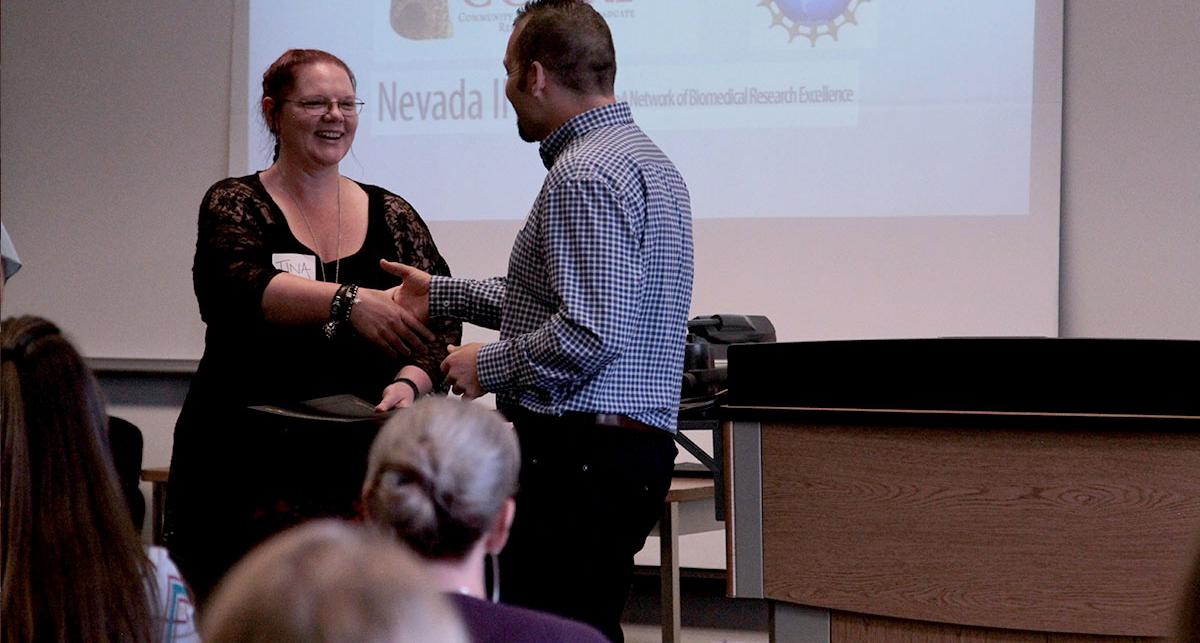 TMCC professor handing student an award.