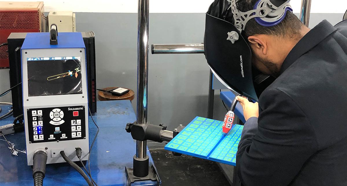 Student testing virtual welding equipment.