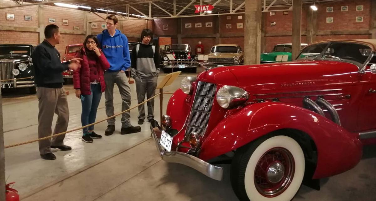 Students in automobile museum.