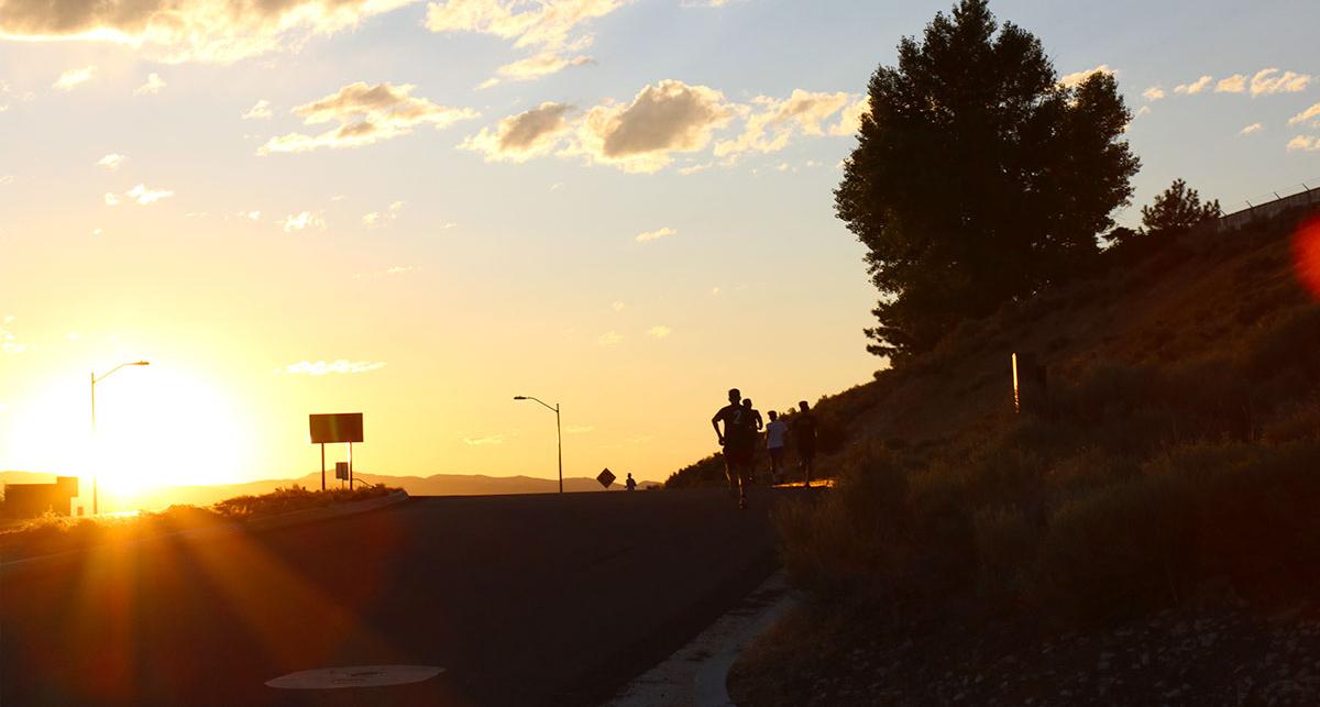 Athlete running at sunrise.