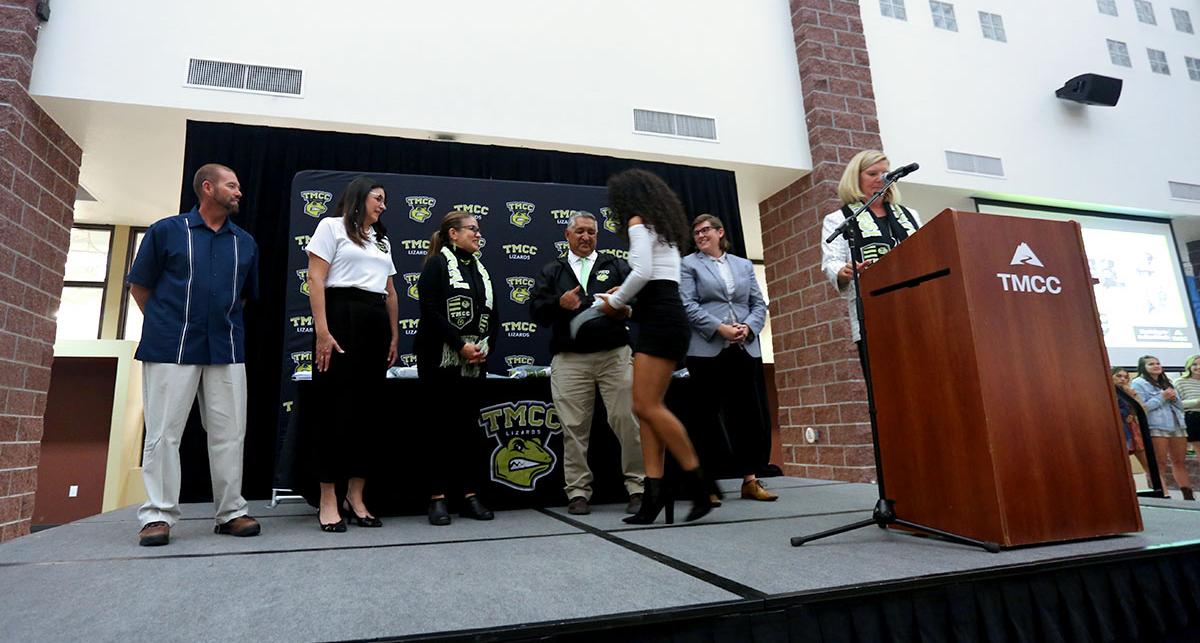 Athletes on stage receiving an award.