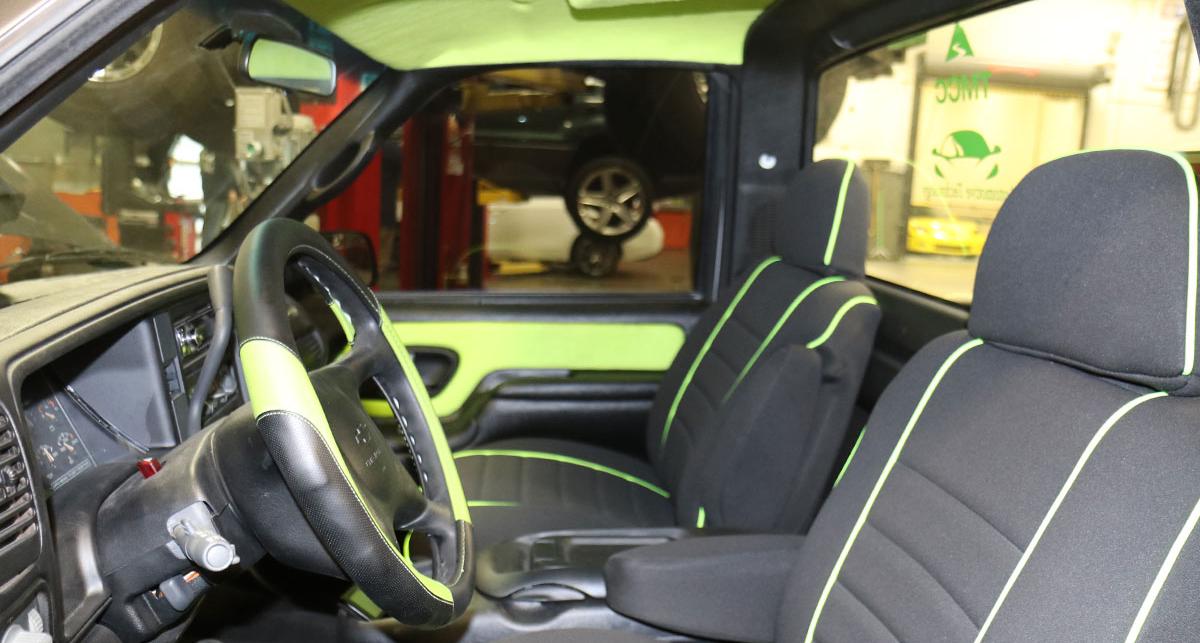 Interior of the truck cab, decorated in black and green.