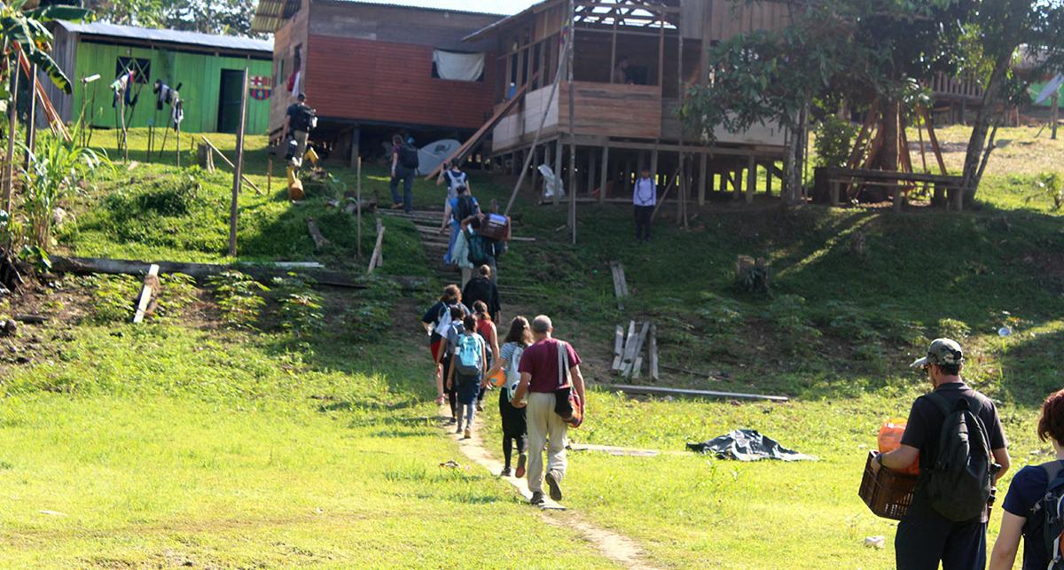 volunteers walking towards a building in the village