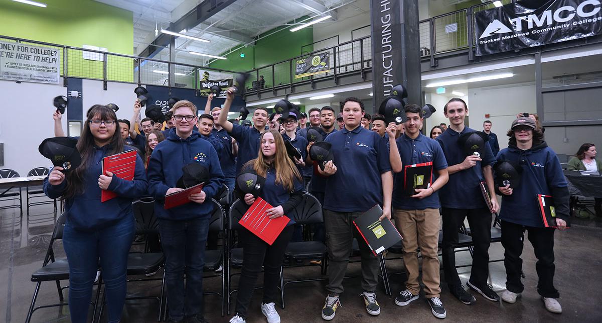 Students toss their caps in the air.