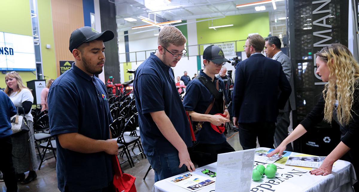 Students speaking with employers at NC3 event.