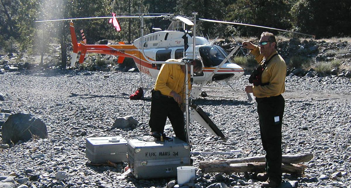 Firefighters set up a mobile weather station on a sandbar