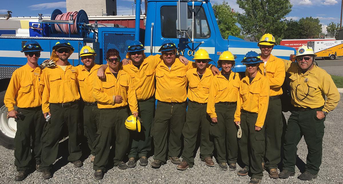 Students in the Basic Wildland Fire Academy pose in front of fire engine