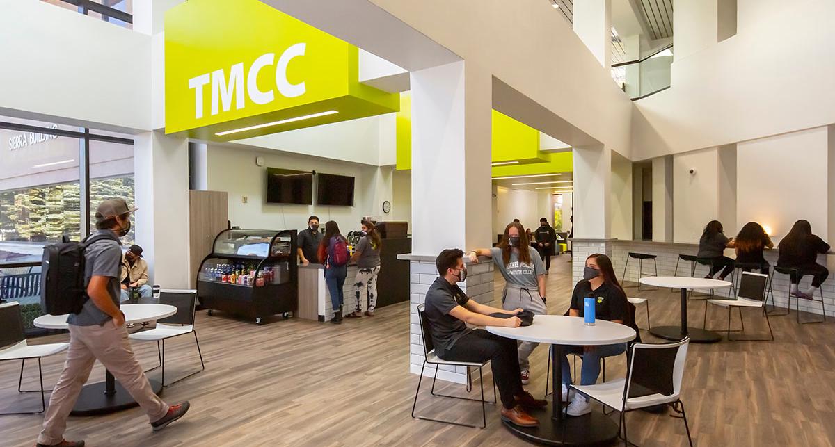 The lobby of the Sierra building, with coffee cart and students sitting at tables.