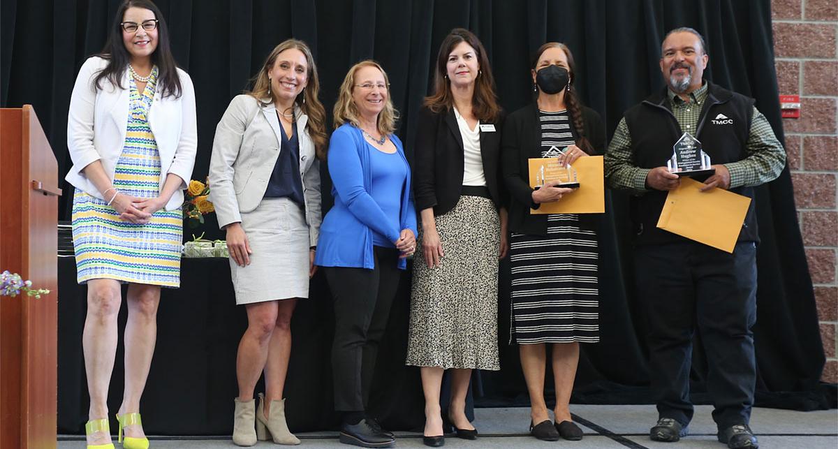 Distinguished Faculty award winners Dr. Micaela Rubalcava and Andy Hughes with a group of presenters.