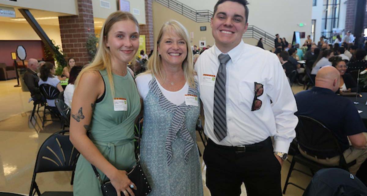  Avery and Molly Lauf pose with recipient Dustin Derley.