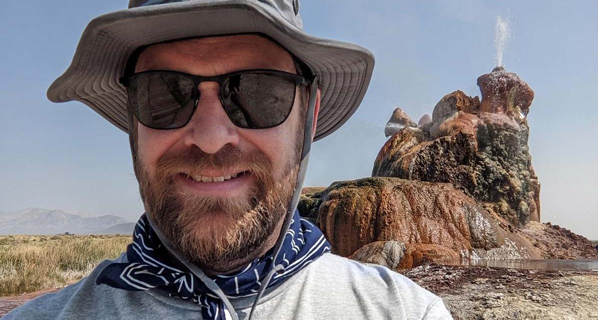 Mark Maynard posing with Fly Geyser in the background.