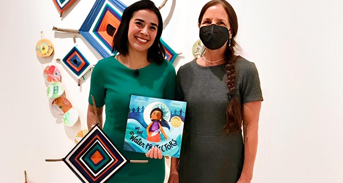 Juliana Urtubey with Professor Micaela Rubalcava in front of a sustainability art display.