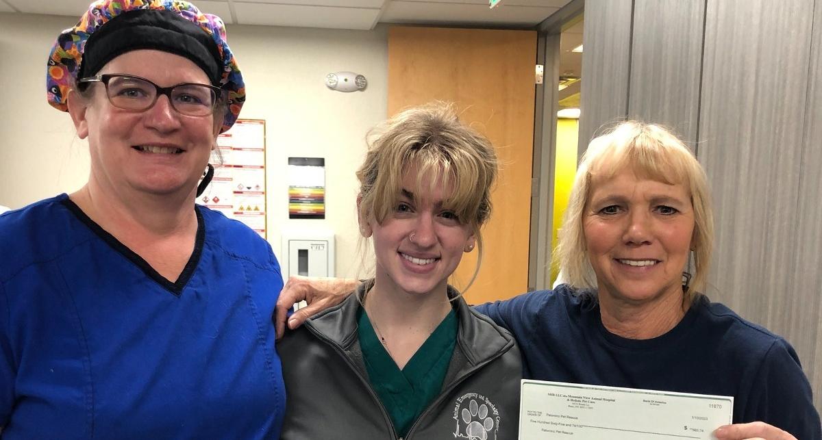 Julie McMahon, Amanda King, and Terri Braunworth (Palomino Valley Pet Rescue) hold up donation check.