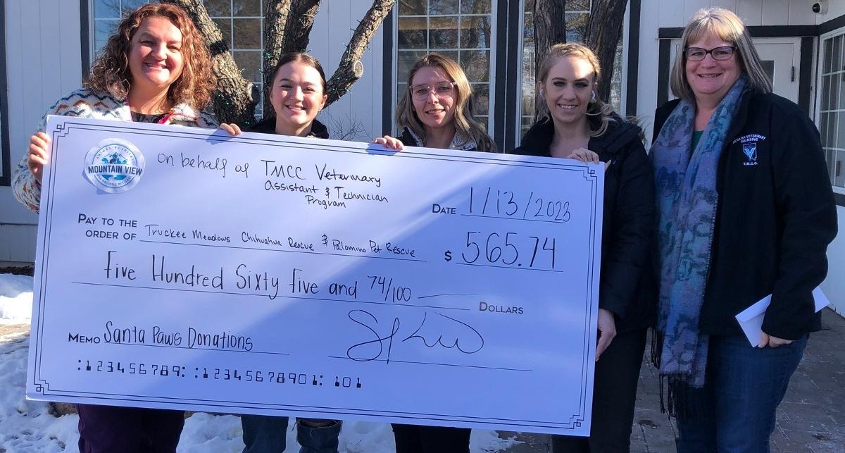 Julie McMahon and vet nursing students present Santa Paws donation check.