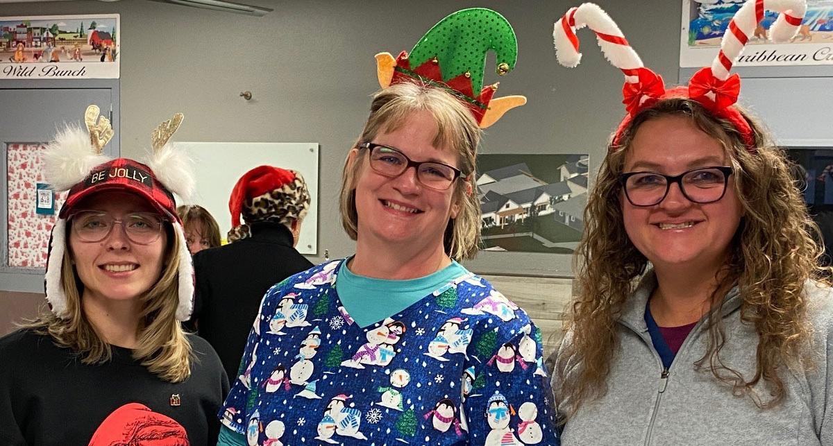 Alicia Angilley, Julie McMahon, and Jillian Fallon dressed up festively for Santa Paws event.