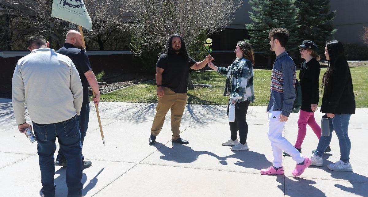 Members of the SGA pass the Bee Baton to the Veterans Resource Center team during the relay.