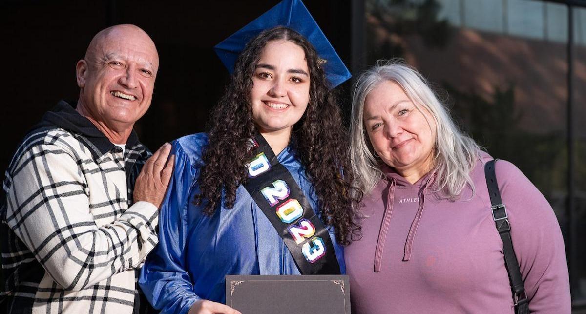 HSE graduate stands proud alongside her loving family members.