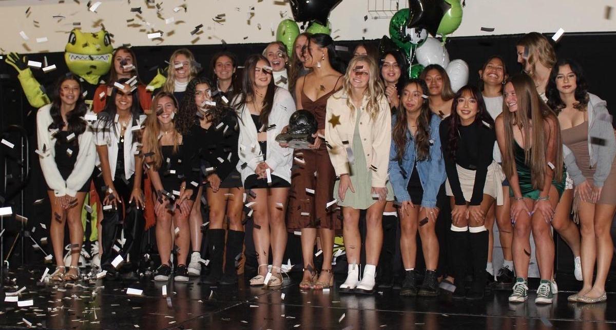 The Women's Soccer team comes together for a photograph during a confetti pop.