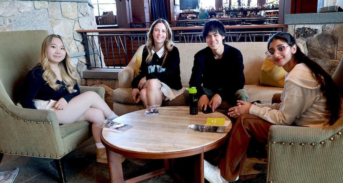 Hospitality students relax in the lobby after completing a hotel tour and its indulging comforts.