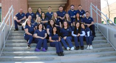 The 2024 Radiologic Technology class smiles while seated, posing for a photograph on the steps of the William N. Pennington Health Science Center.