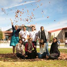 Students throwing leaves