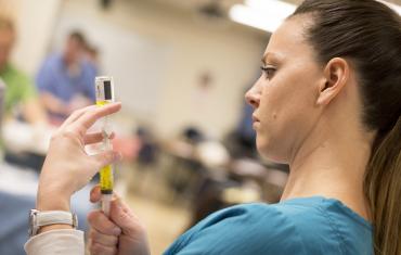 Nursing student with syringe