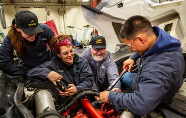 Students working on a diesel engine