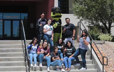 Students sitting on the stairs outside of the student center.