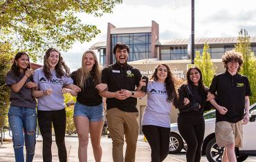 TMCC students with arms together.