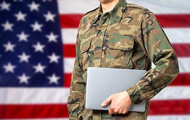 Veteran Student holding a laptop