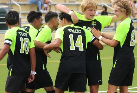 TMCC soccer team celebrating after a goal.