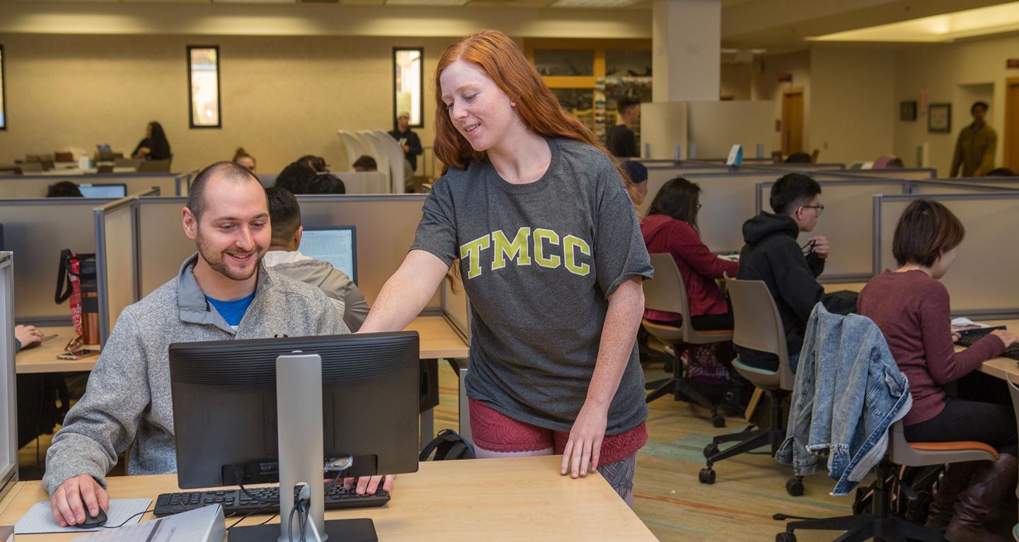 Student helping another student with the computer