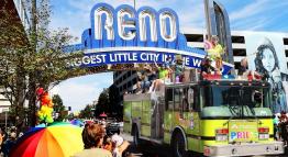 While onlookers cheer, the TMCC green firetruck, with PRIDE written in bold, rainbow letters upfront, moves under the downtown Reno archway with leadership, faculty, and students waving during the parade.