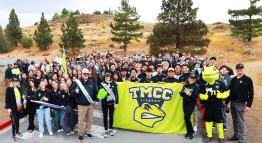 A massive, smiling group of TMCC students, leadership, faculty, and staff, including Mayor Ed Lawson of Sparks, stand united for a historic, encompassing group photo on the marching path.