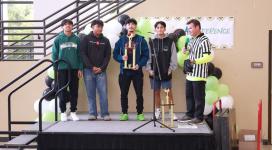 The 3v3 basketball tournament champions accept their trophy from Coach Geoffrey Hawkins.